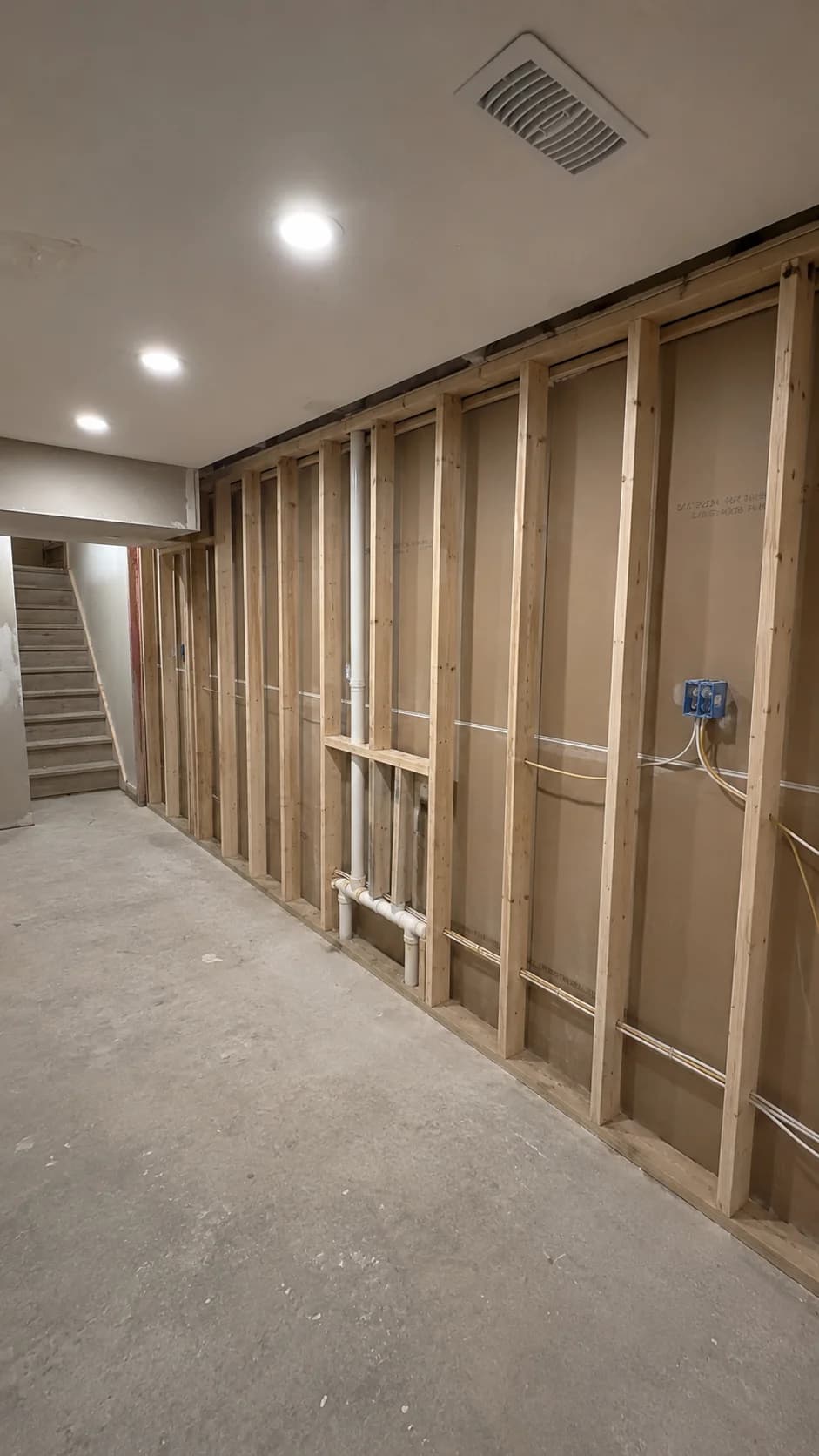 Unfinished concrete basement before renovation
