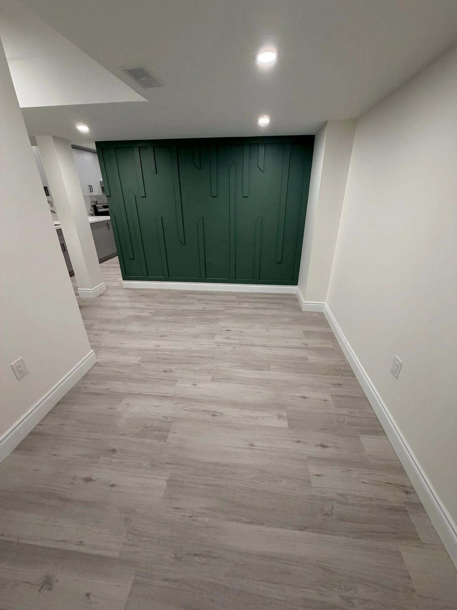 Finished basement apartment after renovation — open living and kitchen area